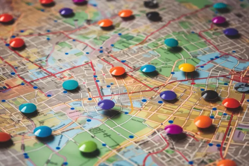 Multicolored pins marking various points on a printed city street map for business directory